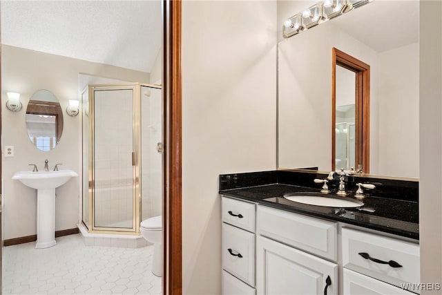 bathroom featuring a shower with door, tile patterned flooring, sink, and toilet