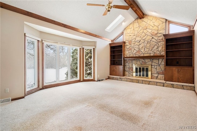 unfurnished living room featuring ceiling fan, a fireplace, and carpet floors