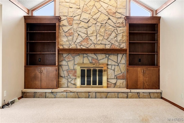 unfurnished living room featuring lofted ceiling, a wealth of natural light, and carpet flooring