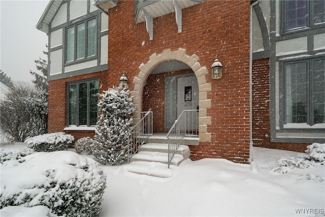 view of snow covered property entrance