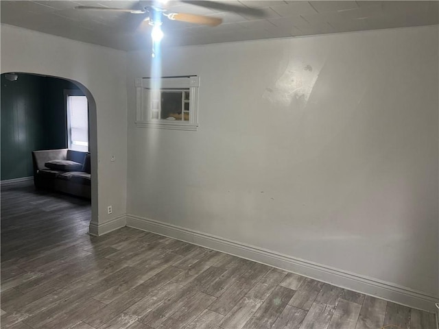 spare room with ceiling fan and wood-type flooring