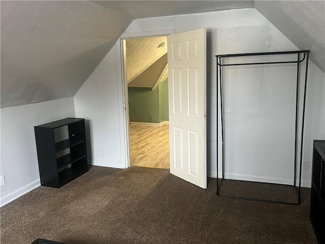 bonus room featuring carpet floors and vaulted ceiling