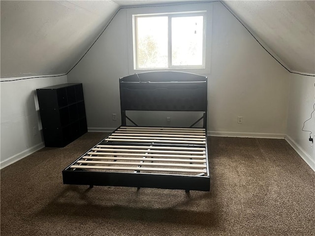 interior space with vaulted ceiling and carpet flooring