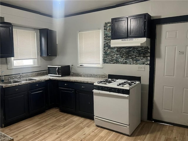 kitchen with sink, light wood-type flooring, and white range with gas stovetop