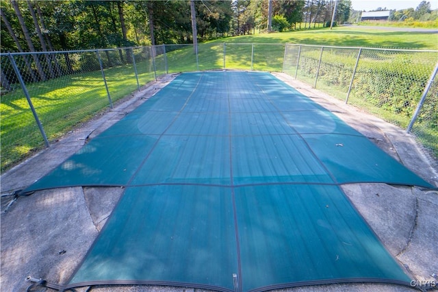 view of swimming pool featuring a lawn