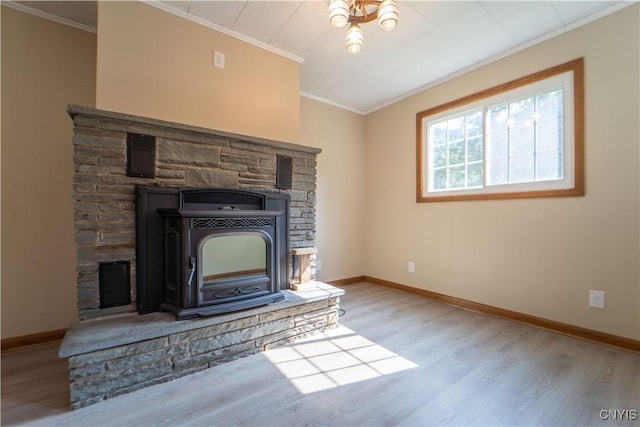 unfurnished living room with ornamental molding, light hardwood / wood-style flooring, and a wood stove