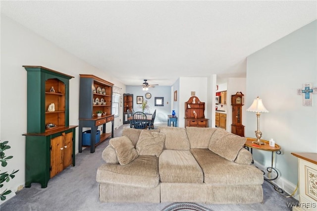 living room featuring light colored carpet and ceiling fan