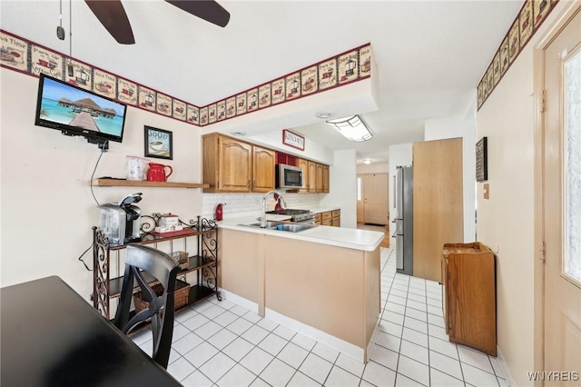 kitchen with ceiling fan, light tile patterned floors, tasteful backsplash, kitchen peninsula, and appliances with stainless steel finishes