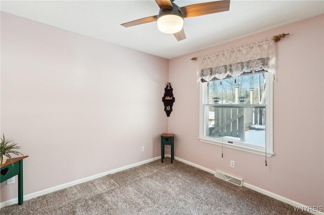 empty room with ceiling fan and carpet flooring