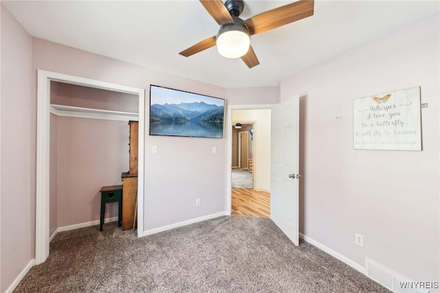 unfurnished bedroom featuring ceiling fan, a closet, and carpet