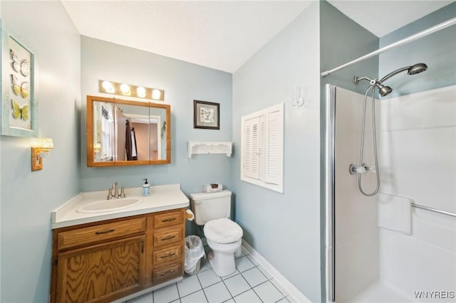 bathroom with vanity, a shower, tile patterned flooring, and toilet