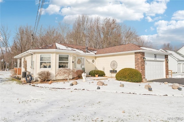 view of front of property with a garage and cooling unit