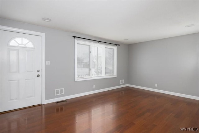 entryway with dark hardwood / wood-style flooring