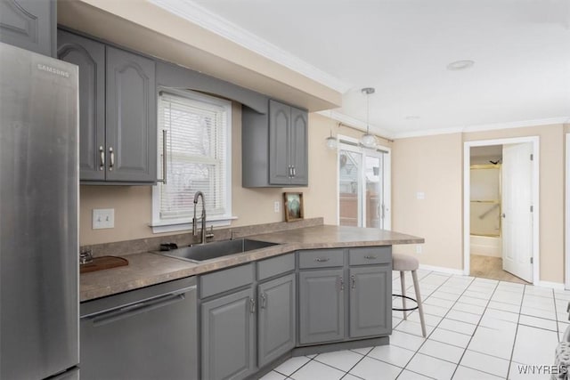 kitchen with decorative light fixtures, appliances with stainless steel finishes, gray cabinetry, and sink