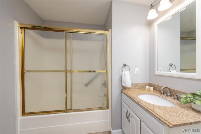 bathroom with vanity and combined bath / shower with glass door