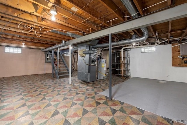 basement featuring water heater and heating unit