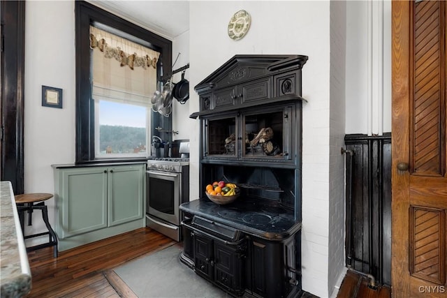 kitchen with gas range, dark hardwood / wood-style floors, and green cabinets