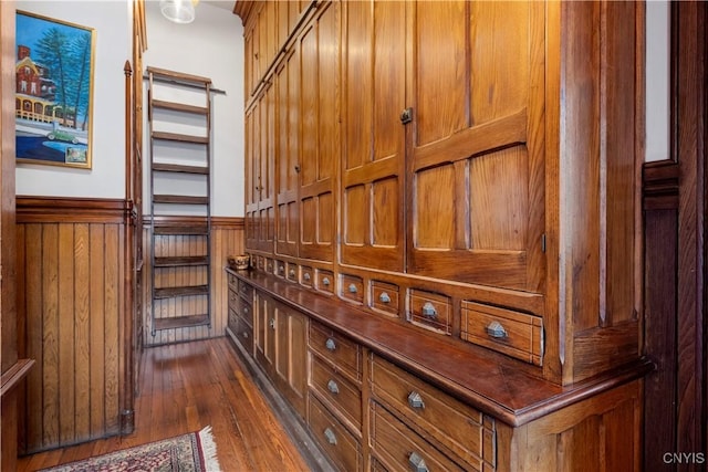 interior details featuring wooden walls and hardwood / wood-style floors