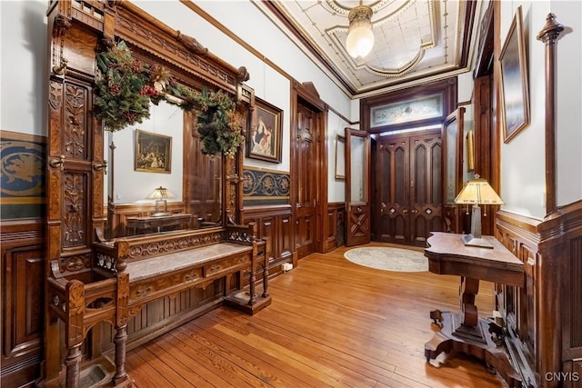 interior space featuring ornamental molding and light wood-type flooring