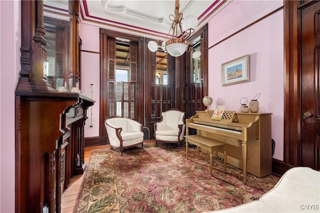 living area with a tray ceiling and crown molding