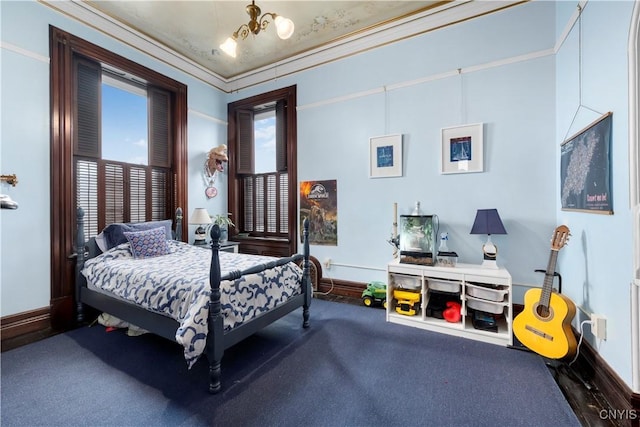 bedroom with an inviting chandelier, carpet floors, ornamental molding, and multiple windows