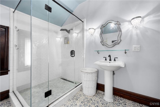 bathroom featuring walk in shower, tile patterned flooring, and vaulted ceiling