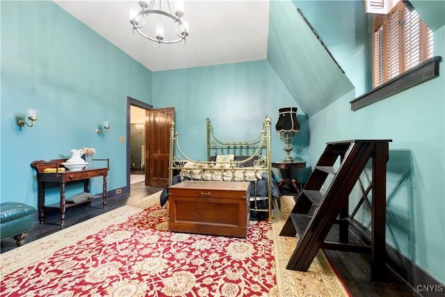 bedroom featuring an inviting chandelier and lofted ceiling