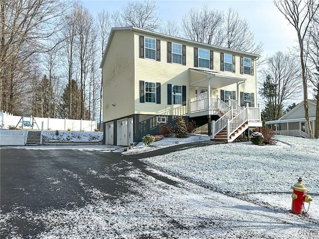 view of front of home featuring covered porch and a garage