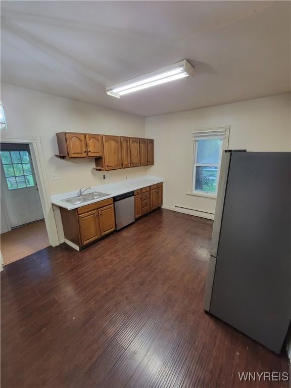 kitchen with stainless steel appliances, a baseboard radiator, a wealth of natural light, and sink