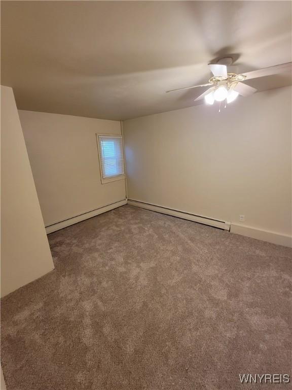 spare room with ceiling fan and carpet