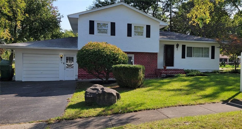 tri-level home with a front yard and a garage