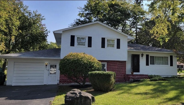 view of front of property featuring a garage and a front lawn