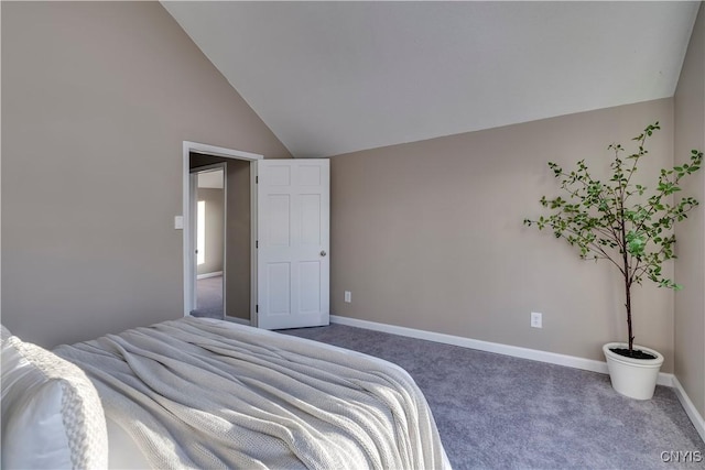 bedroom with lofted ceiling and carpet floors