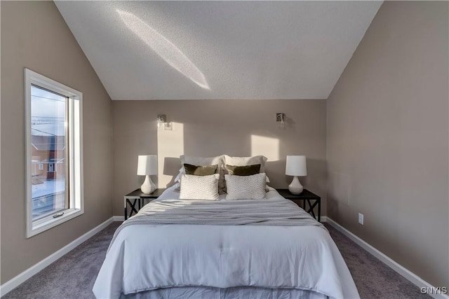 carpeted bedroom featuring a textured ceiling and lofted ceiling