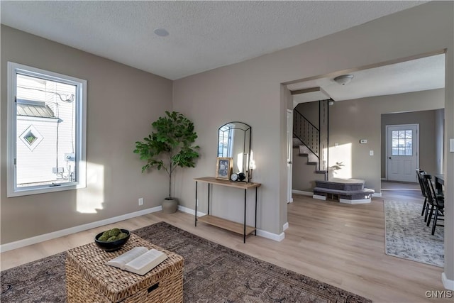 entrance foyer featuring a textured ceiling and light hardwood / wood-style floors