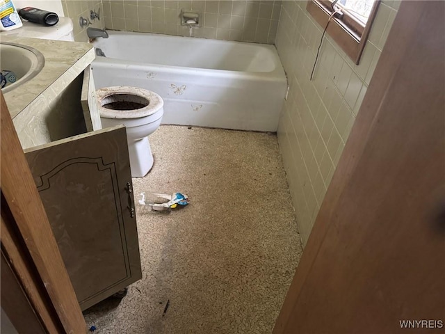 bathroom featuring a bathtub, vanity, and toilet