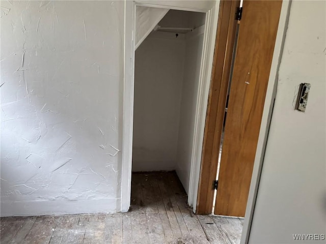 hallway with light hardwood / wood-style floors