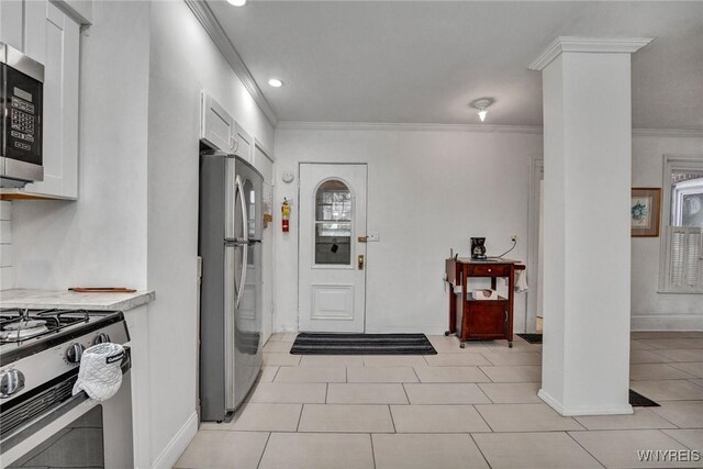 tiled entrance foyer featuring ornamental molding