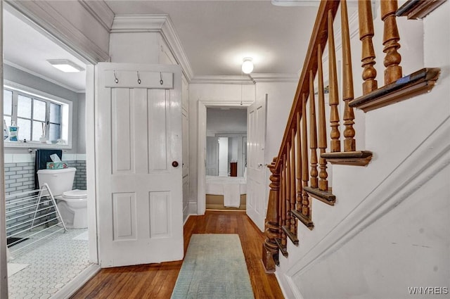 entrance foyer with hardwood / wood-style floors and crown molding