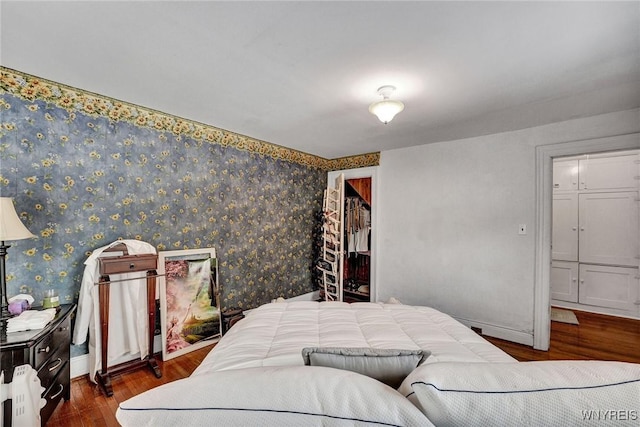 bedroom with dark hardwood / wood-style flooring