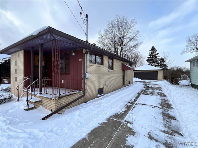 view of front of property featuring a garage and an outbuilding