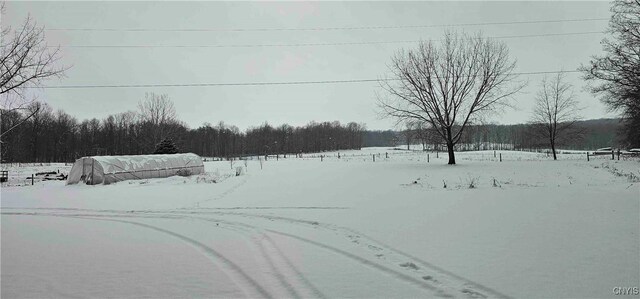 view of yard layered in snow