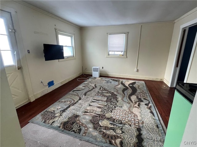 living room with dark hardwood / wood-style flooring and crown molding