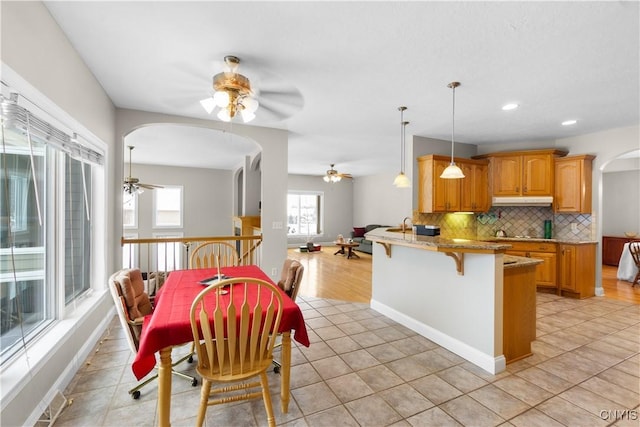 dining room featuring ceiling fan and light tile patterned flooring