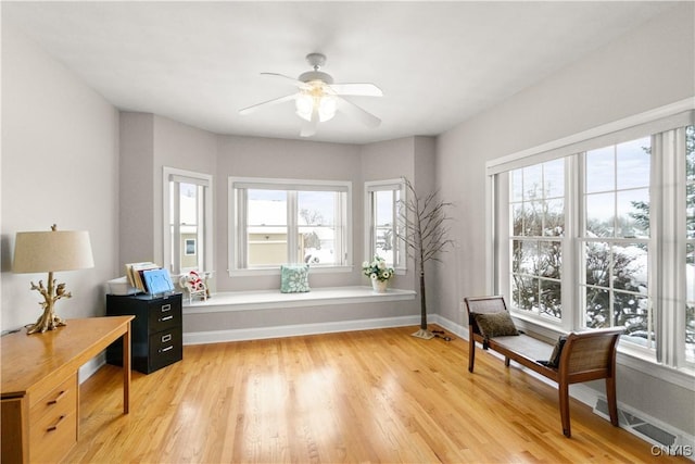 sitting room with ceiling fan, light hardwood / wood-style flooring, and a wealth of natural light