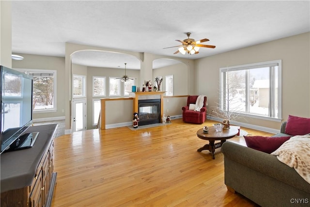 living room with light hardwood / wood-style floors and ceiling fan