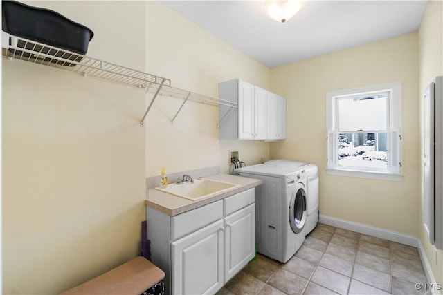 washroom featuring independent washer and dryer, cabinets, and sink