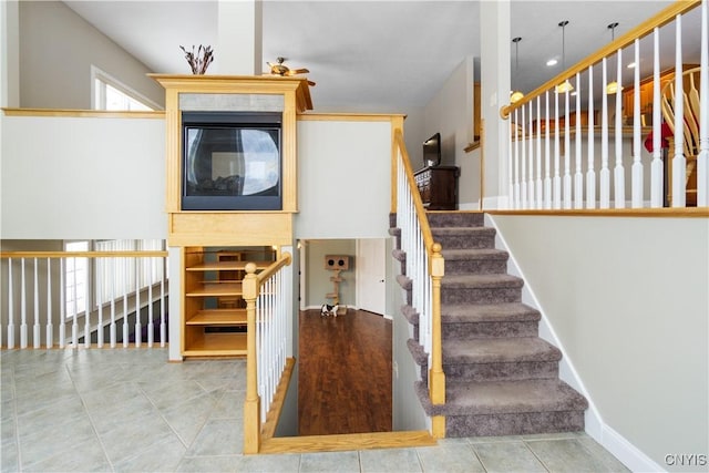 staircase featuring tile patterned flooring