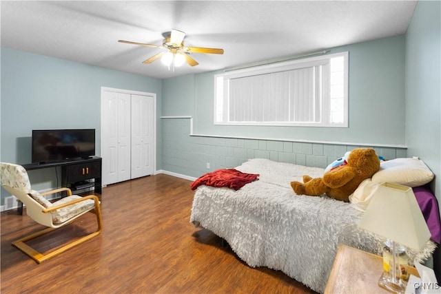 bedroom with wood-type flooring, a closet, and ceiling fan