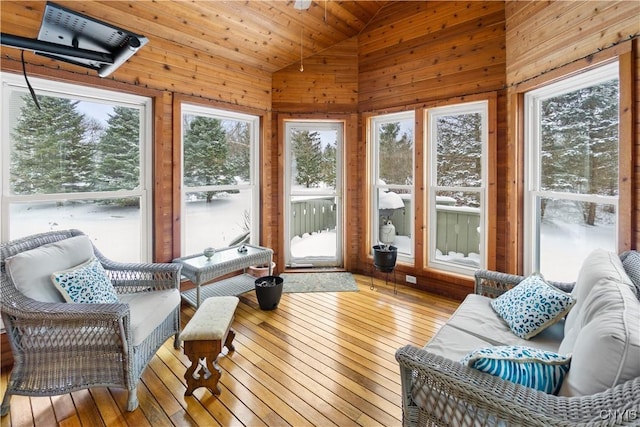 sunroom / solarium with wood ceiling, a wealth of natural light, and lofted ceiling